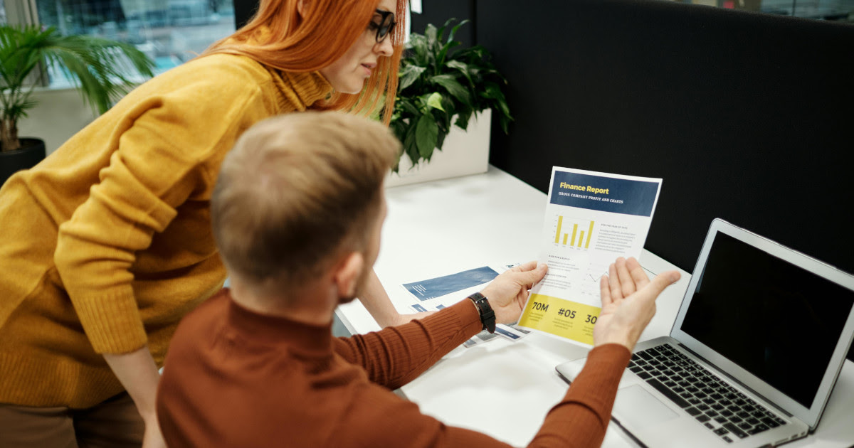 Healthcare analytics leader monitoring clinical data dashboards and AI insights on a laptop